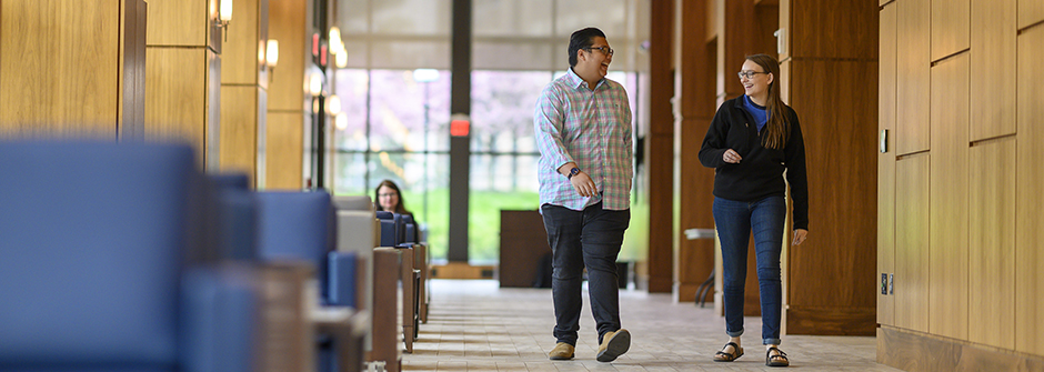 Students walking and talking in Bethany Hall.