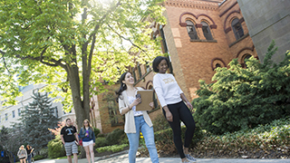 students walking along the side walk at Seton Hall University Campus