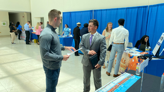 Student discusses employment opportunities with employer at the Career Fair. 