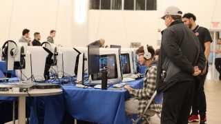 Student at a DELL computer with headphones participating in an Esports match.