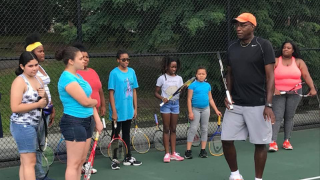 Retired tennis professional and Director of Tennis for GNTE, Bob Bynum with players during one of the summer sessions. 