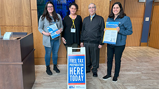 Photo of Danielle DiMeglio, Monica Conover (United Way of Northern NJ), Avery Neumark and Danielle Corea-Smith (United Way of Greater Newark) welcoming visitors to the first tax prep session on March 14, 2023.