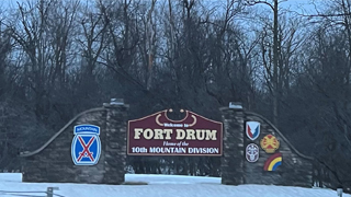 Sign outside the wintry Fort Drum reading 