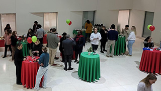 Graduate students attend Christmas social event.