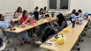 A photo of students crocheting.