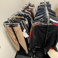 A photo of clothes on a rack.