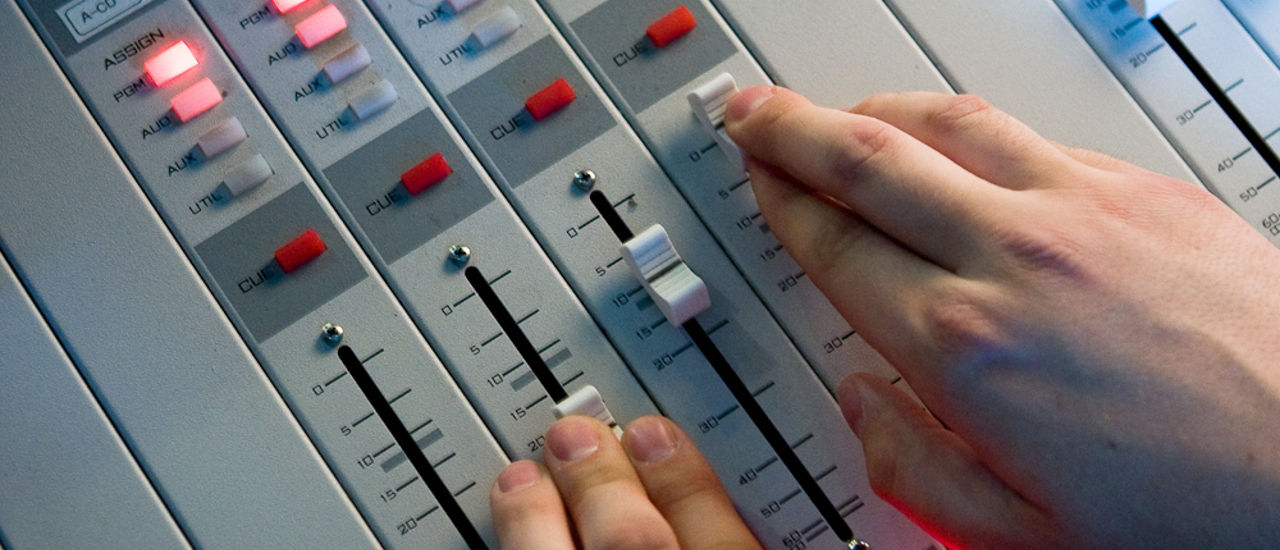 Image of a hand touching a sound board 