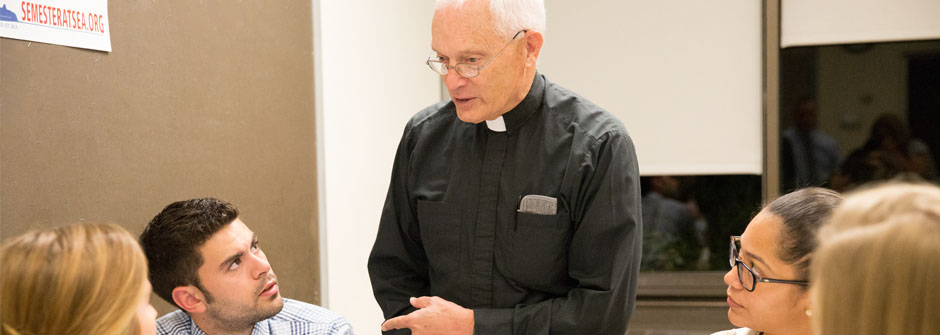 Priest lecturing in class