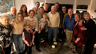 A photo of the Karten Family celebrating Thanksgiving with Seton Hall students.