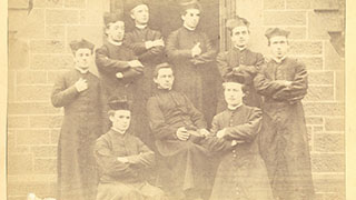 1870s. Seminarians on the chapel steps; unidentified professor in middle. - AAN