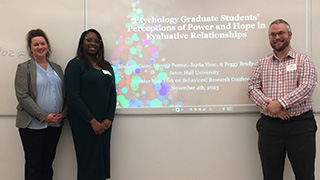 Doctoral candidates present research.